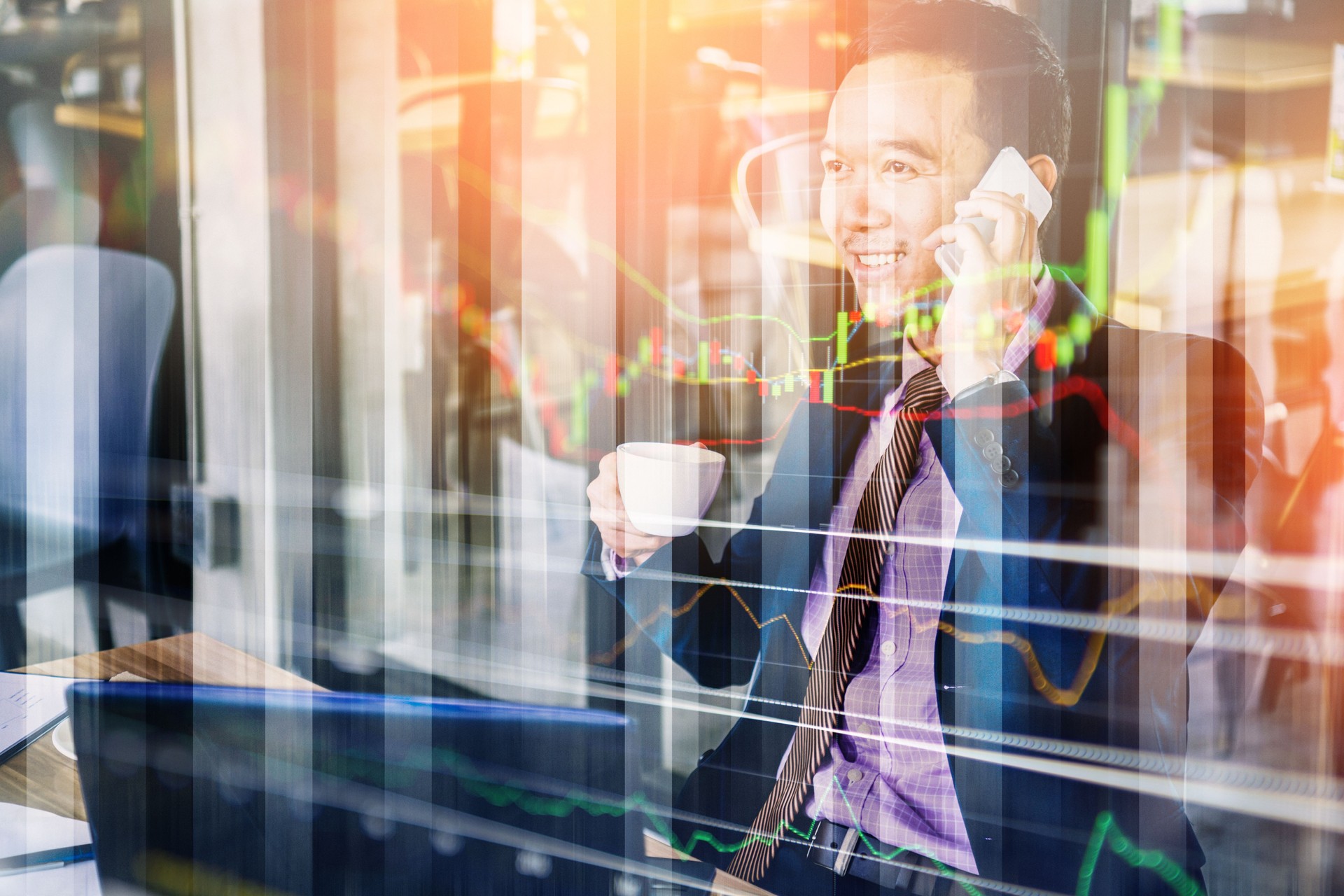 business asian man working outdoor woth coffee and laptop business concept with double exposure with graph stock market and cityscape background